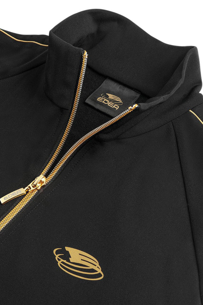 Black and gold women's figure skating training jacket, model Dream Gold Jacket Lady by EDEA, close up front view -Maison du Patin
Veste d'entraînement de patinage artistique pour femme noire et dorée, modèle Dream Gold Jacket Lady par EDEA, vue rapprochée de face - Maison du Patin
 
DGJACKETL